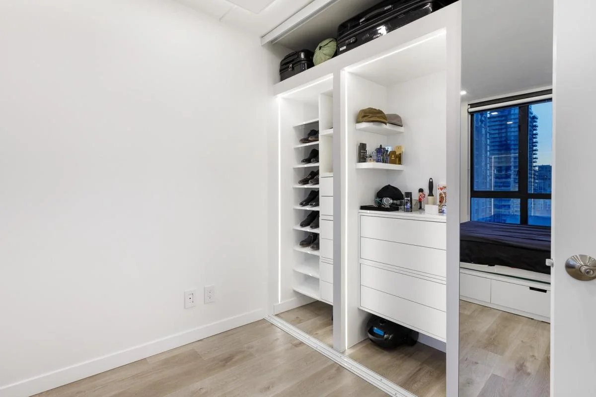 Custom walk-in closet with mirror doors and LED strip lighting — interior finishing by True Vision Construction