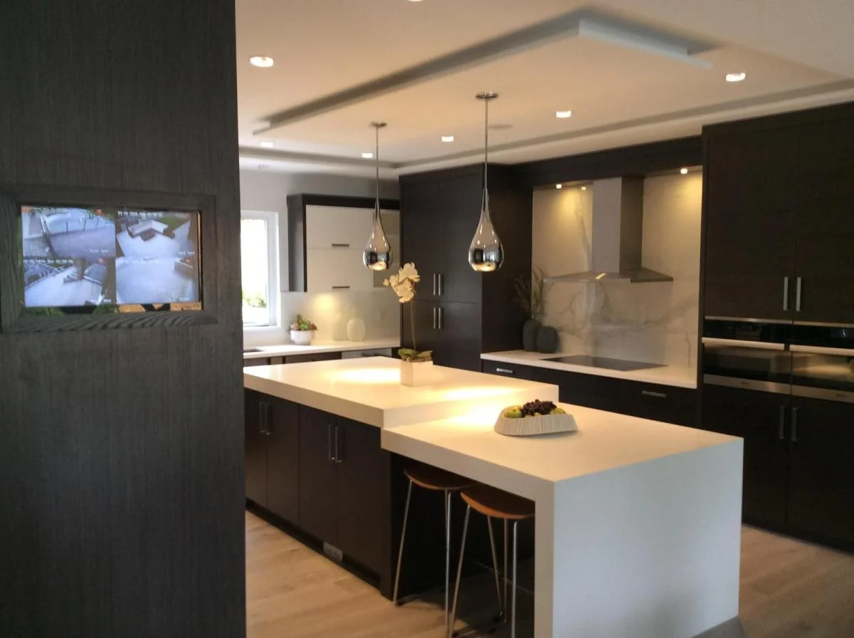 Modern luxury kitchen renovation with dark custom cabinetry and pendant lighting by True Vision Construction, West Vancouver