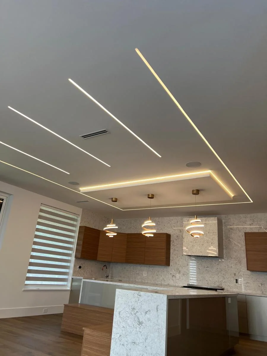 Modern kitchen with designer LED ceiling lighting, marble countertops, and spiral pendant fixtures